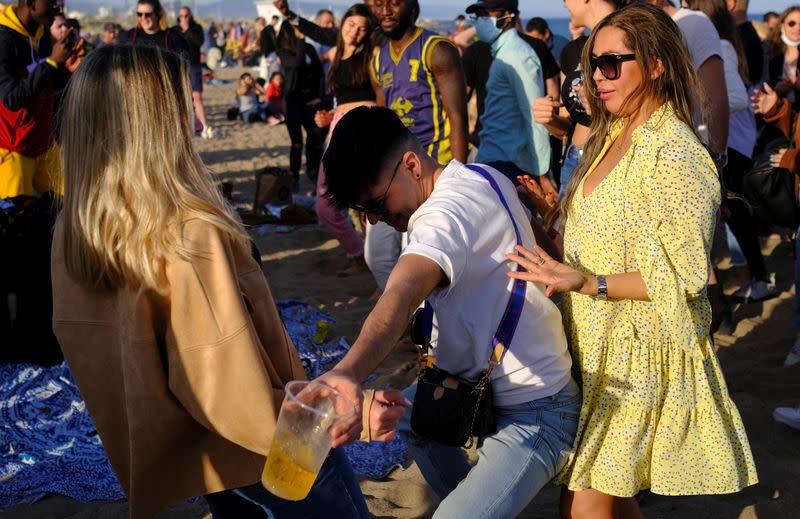 People dance at Barceloneta beach, amid the coronavirus disease (COVID-19) outbreak, in Barcelona