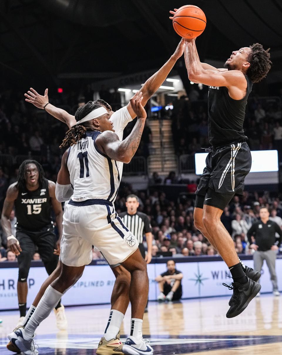 Xavier Musketeers guard Desmond Claude (1) shoots the ball against Butler Bulldogs guard Jahmyl Telfort (11) on Wednesday, March 6, 2024, during the game at Hinkle Fieldhouse in Indianapolis. The Butler Bulldogs defeated the Xavier Musketeers, 72-66.