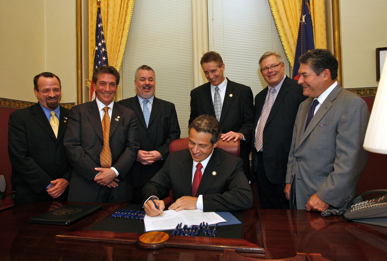 Image: Gov. Andrew Cuomo signs the Marriage Equality Act, with Harry Bronson, Matthew Titone, Daniel O'Donnell, Bob Duffy, Tom Duane and James Alesi, on June 24, 2011. (Judy Sanders / Office of Andrew M. Cuomo)