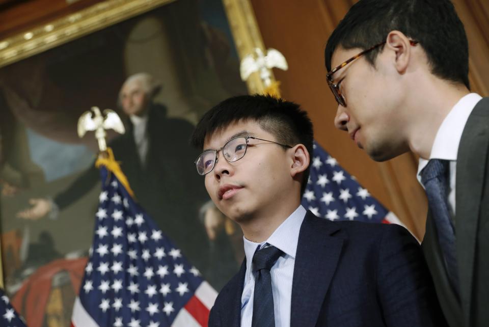 FILE - In this Sept. 18, 2019, file photo, Hong Kong activists Joshua Wong and Nathan Law, right, participate in a news conference on Hong Kong Human Rights on Capitol Hill in Washington. Law gained prominence as a student protest leader before winning election to Hong Kong's legislature in 2016. He later was expelled and jailed several months for his activism. Law had hopes of keeping a low profile and immersing himself in studies at Yale University in New Haven, Conn., but found his role as a Hong Kong protest leader defining him even half a world away. (AP Photo/Pablo Martinez Monsivais, File)