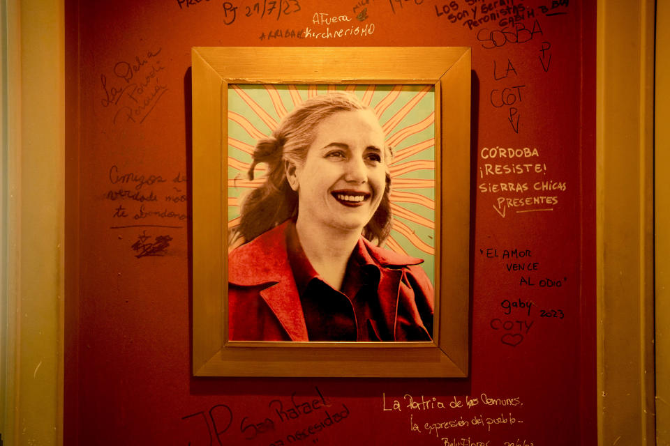 A framed image of Argentine former first lady María Eva Duarte de Perón, better known as Eva Perón, or Evita, hangs from a wall scrawled with hand written messages, at the Peron Peron restaurant in the Palermo neighborhood of Buenos Aires, Argentina, Tuesday, Jan. 23, 2024. (AP Photo/Natacha Pisarenko)