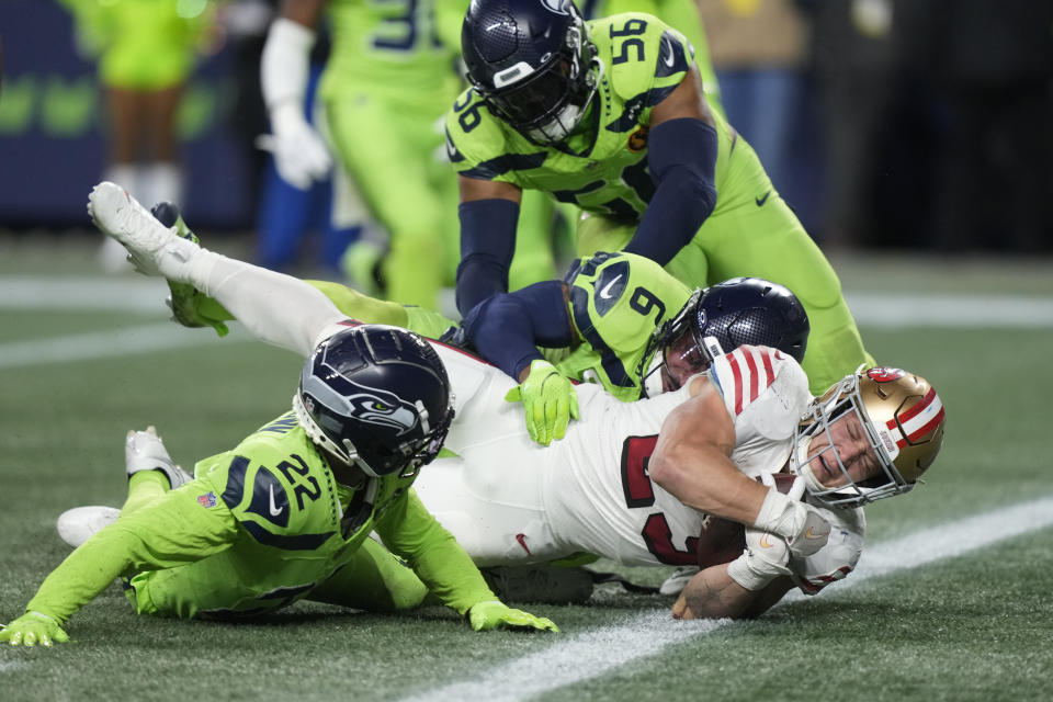 San Francisco 49ers running back Christian McCaffrey (23) falls into the endzone for a touchdown during the first half of an NFL football game against the Seattle Seahawks, Thursday, Nov. 23, 2023, in Seattle. (AP Photo/Stephen Brashear)