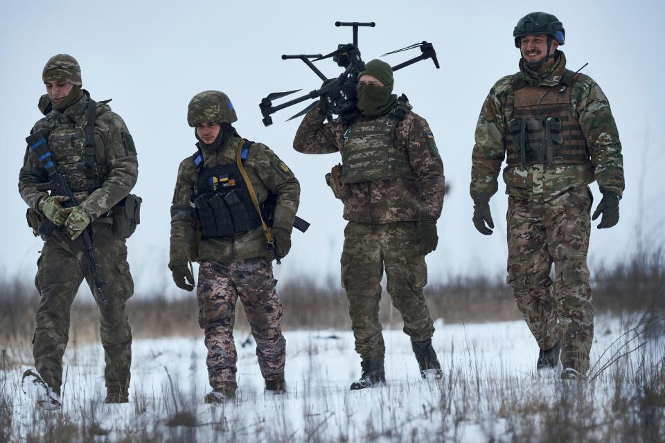 Ukrainian soldiers carry a drone close to the frontline near Avdiivka, Donetsk region, Ukraine, Friday, Feb. 17, 2023.