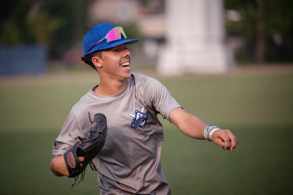 Auburn Senior Little League's Bryce Everson laughs while playing catch during Monday's practice.