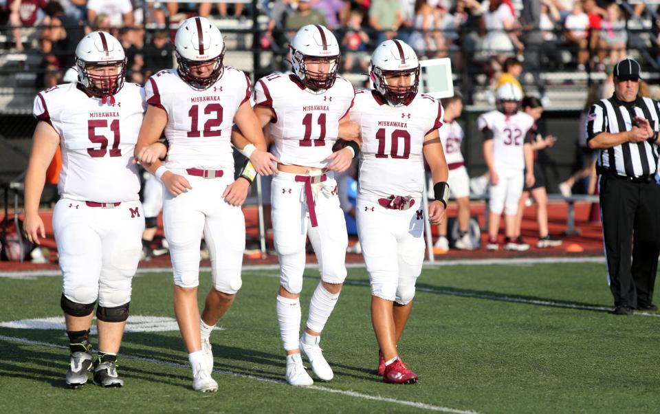 The Mishawaka football captains walk to the 50-yard-line for the coin toss during the Mishawaka vs. Penn football game Friday, Aug. 25, 2023, at Freed Field. The Kingsmen won over the Cavemen, 28-7.