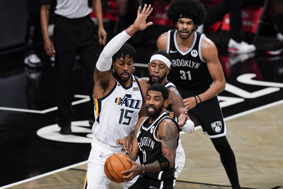 Utah Jazz's Derrick Favors (15) defens Brooklyn Nets' Kyrie Irving (11) during the second half of an NBA basketball game Tuesday, Jan. 5, 2021, in New York. (AP Photo/Frank Franklin II)