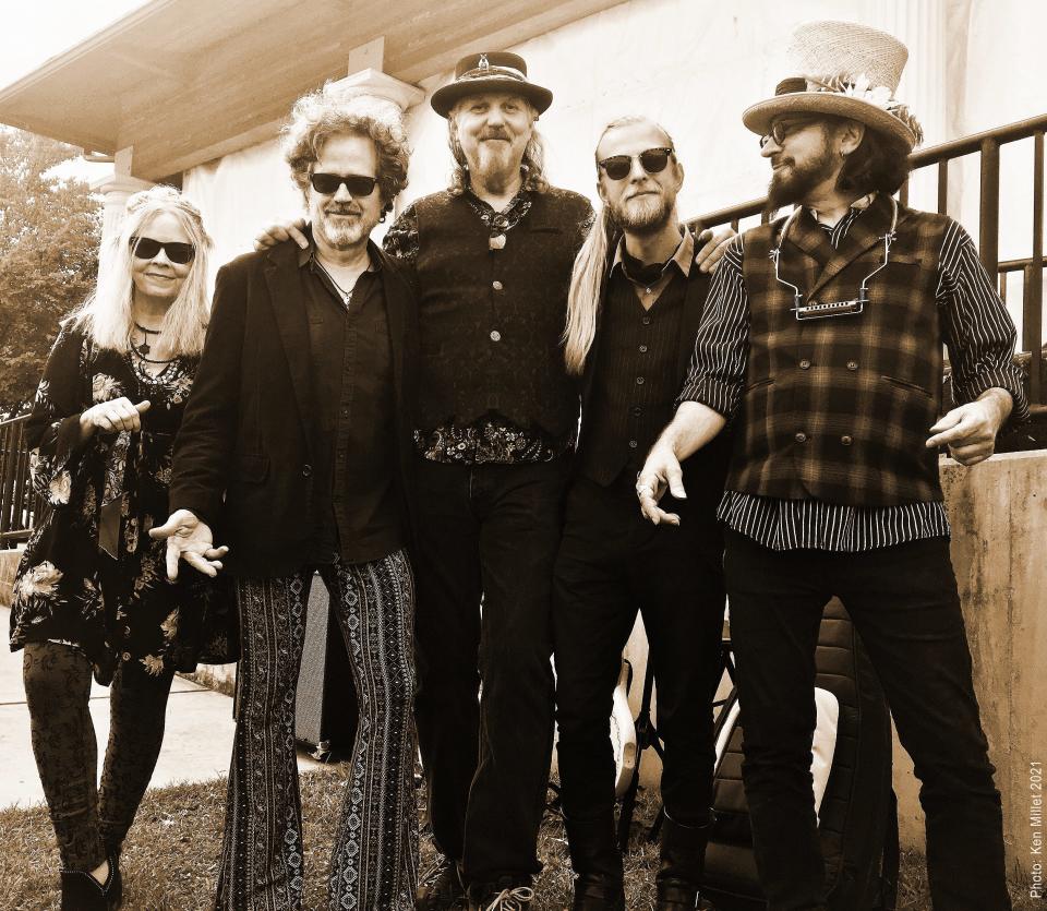 A sepia-toned image of the Slambovian Circus of Dreams. From left: multi-instrumentalist Tink Lloyd, guitarist and backing vocalist Sharkey McEwen, drummer Matthew Abourezk, multi-instrumentalist RJ McCarty, lead vocalist and songwriter Joziah Longo