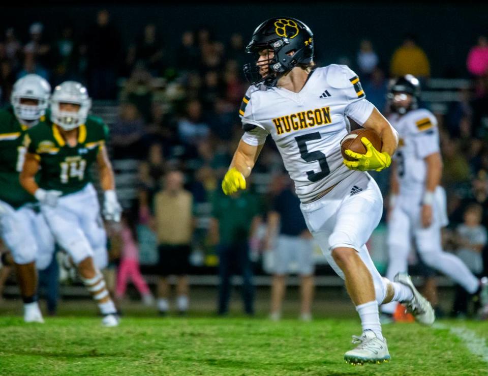 Larkin Meyer, 5, of Hughson High works his way up field with Hilmar Highs defense closing in during the first half of Friday Oct. 20, 2023 nights game at Hilmar.