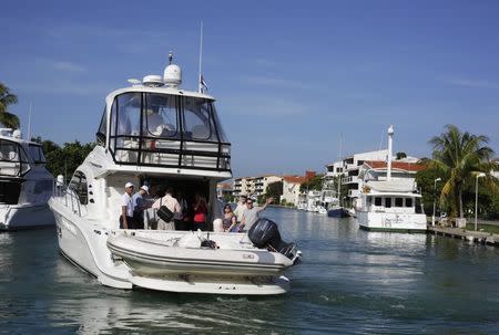 Patrick Hemingway, grandson of the late U.S. author Ernest Hemingway, waves from a yacht at the Marina Hemingway in Havana September 8, 2014. REUTERS/Enrique De La Osa