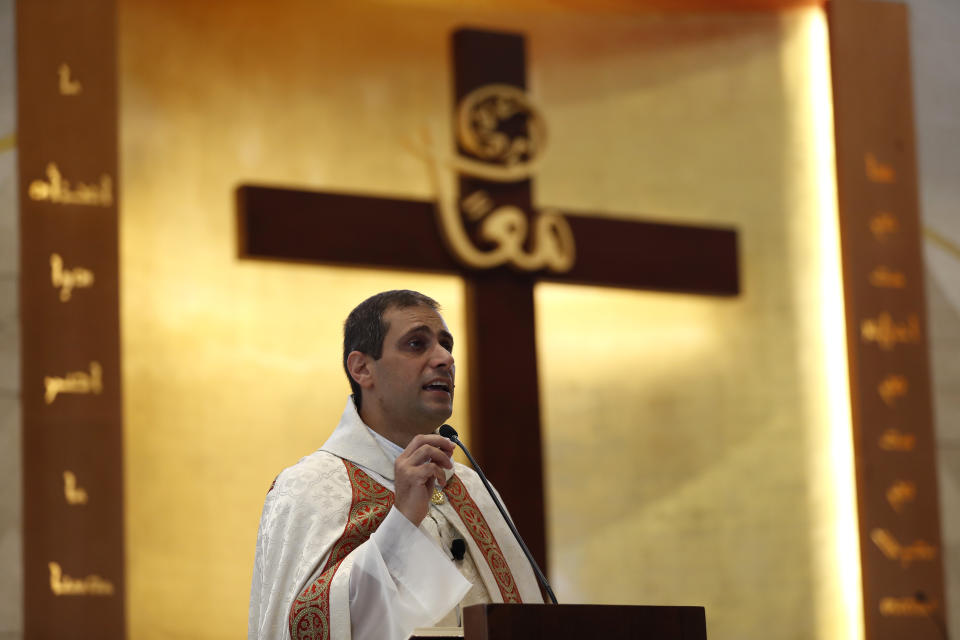 Lebanese priest Marwan Mouawad, speaks during Sunday Mass at Saint Maron-Baouchrieh Church that was damaged by last Tuesday's explosion that hit the Beirut seaport, in Baouchrieh neighborhood in Beirut, Lebanon, Sunday, Aug. 9, 2020. In interviews with The Associated Press, Father Rabih Thoumy and church priest Father Marwan Mouawad recount the horror of the moment the blast rocked the church. Thoumy says: "God has saved us.” (AP Photo/Hussein Malla)