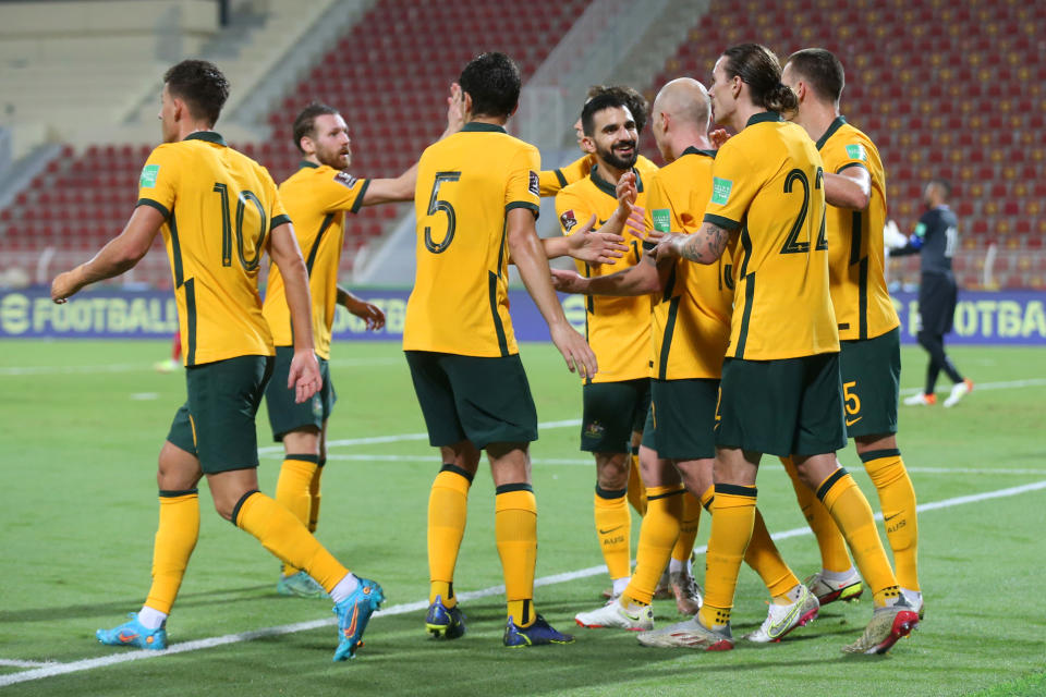 MUSCAT, OMAN - FEBRUARY 01: Aaron Mooy of Australia (hidden) celebrates with teammates after scoring their team's second goal during the FIFA World Cup Qatar 2022 Qualifier match between Oman and Australia at Sultan Qaboos Sports Complex on February 01, 2022 in Muscat, Oman. (Photo by Adil Al Naimi/Getty Images)