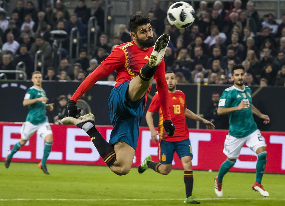 Diego Costa leaps and lunges for a ball in a friendly between Spain and Germany. He makes our 2018 World Cup top 50, as do the three players in the background. (Getty)