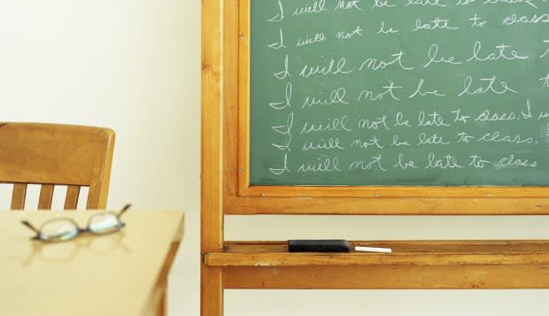 Repeated text written on blackboard in classroom