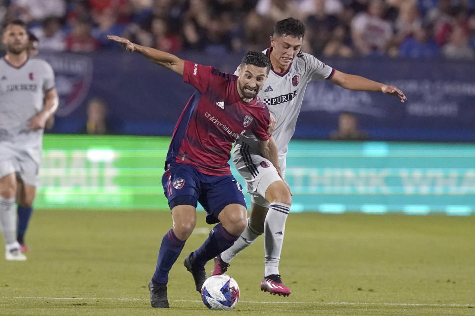 FC Dallas midfielder Sebastian Lletget, left, and Sporting Kansas City defender Logan Ndenbe vie for control of the ball during the first half of an MLS soccer match Saturday, May 6, 2023, in Frisco, Texas. (AP Photo/LM Otero)