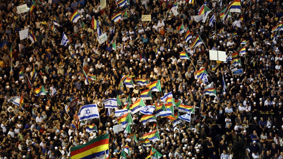 Israelis from the Druze minority, together with others, held Israeli and Druze flags in a rally to protest against the nation-state law in Tel Aviv, Israel, in 2018. - Corinna Kern/Reuters