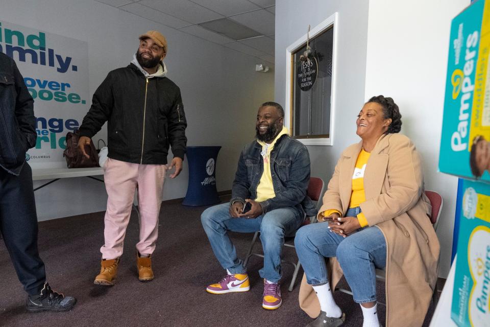 All Nations Worship Assembly Columbus Pastor Julius Lancaster, from left, Phil Guess and Tyann Guess talk while volunteering at a gift drive Saturday to benefit the Thomas twins, Kyair and Kason, who were recently found after being abducted.