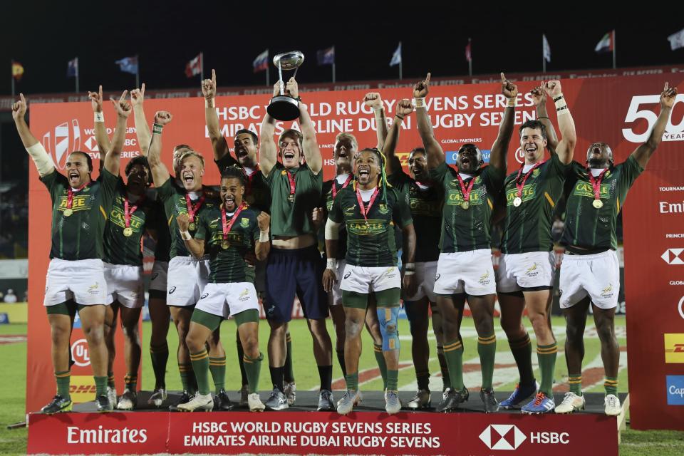 South Africa's players celebrate with the trophy after they defeated New Zealand in the final match of the Emirates Airline Rugby Sevens in Dubai, United Arab Emirates, Saturday, Dec.7, 2019. (AP Photo/Kamran Jebreili)