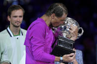 Rafael Nadal of Spain kisses the Norman Brookes Challenge Cup after defeating Daniil Medvedev of Russia in the men's singles final at the Australian Open tennis championships in Melbourne, Australia, early Monday, Jan. 31, 2022. (AP Photo/Andy Brownbill)