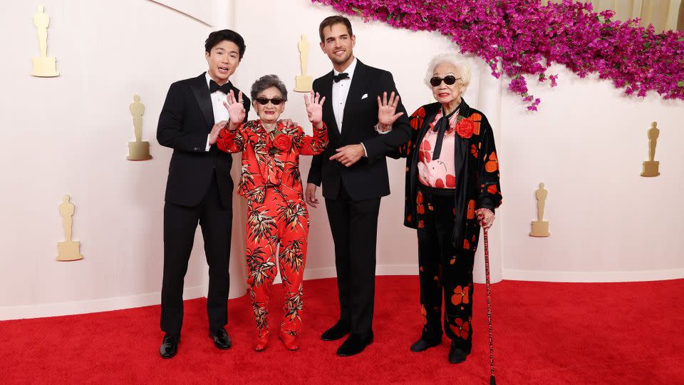 Sean Wang and Sam Davis, nominated for their short documentary “Nai Nai & Wai Po” (or “Grandma & Grandma”), pose alongside the film’s subjects, Chang Li Hua and Yi Yan Fuei — both of whom wore custom Rodarte. - Kevin Mazur/Getty Images