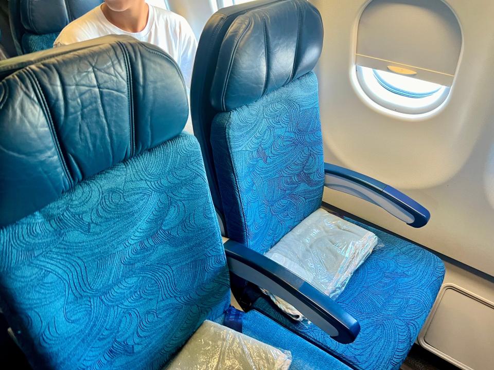 A pair of blue seats onboard Hawaiian Airlines.