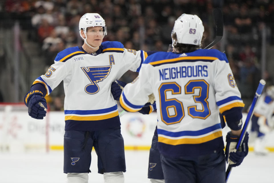 St. Louis Blues defenseman Colton Parayko celebrates with left wing Jake Neighbours (63) after scoring a goal against the Arizona Coyotes during the first period during an NHL hockey game Wednesday, Nov. 22, 2023, in Tempe, Ariz. (AP Photo/Rick Scuteri)