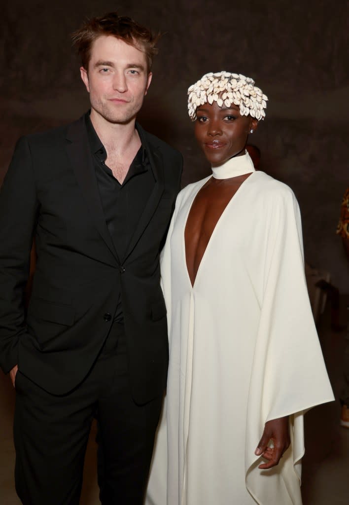 Robert Pattinson (L) and Lupita Nyong’o