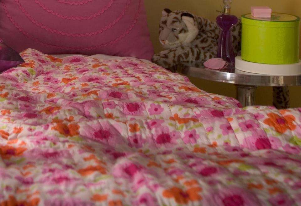 girl's bed with pink flower comforter