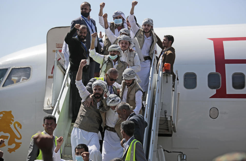 Yemeni prisoners chant slogans during their arrival after being released by the Saudi-led coalition at the airport in Sanaa, Yemen, Thursday, Oct. 15, 2020. (AP Photo/Hani Mohammed)