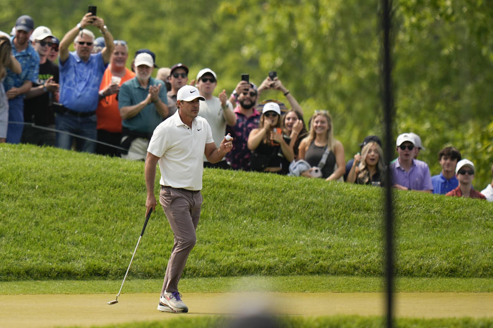 Brooks Koepka waves after his putt on the third hole during the final round of the PGA Championship golf tournament at Oak Hill Country Club on Sunday, May 21, 2023, in Pittsford, N.Y. (AP Photo/Eric Gay)