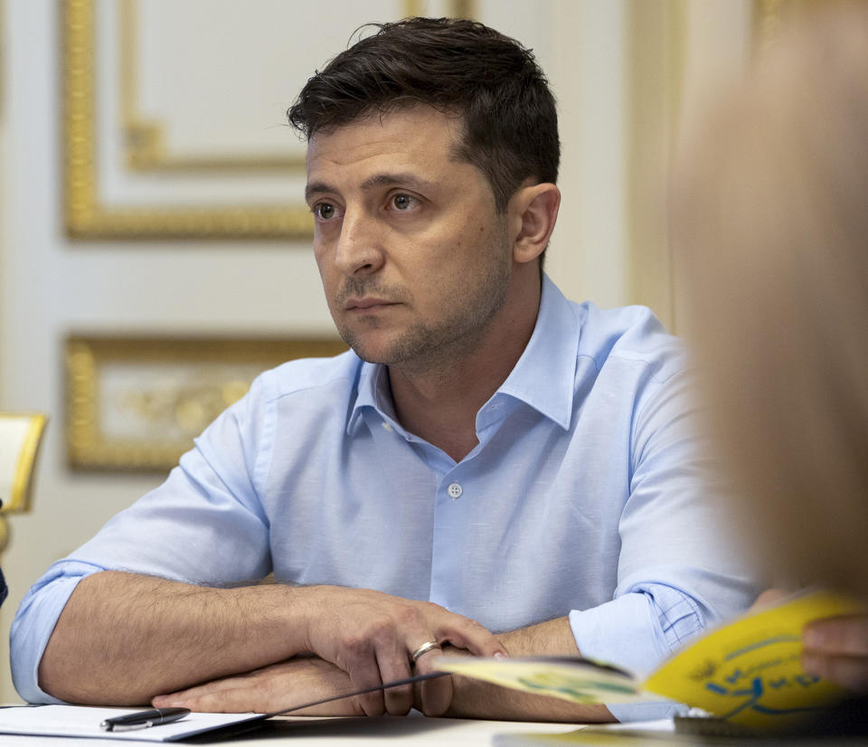 Ukrainian President Volodymyr Zelenskiy listens during a meeting with the lawmakers in Kiev, Ukraine, Tuesday, May 21, 2019. Ukraine's new president has signed a decree dissolving the parliament and calling a snap election in two months. (Ukrainian Presidential Press Office via AP)