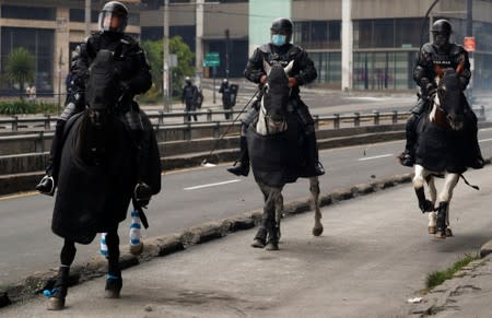 Mounted police members patrol during protests after Ecuador's President Lenin Moreno's government ended four-decade-old fuel subsidies in Quito