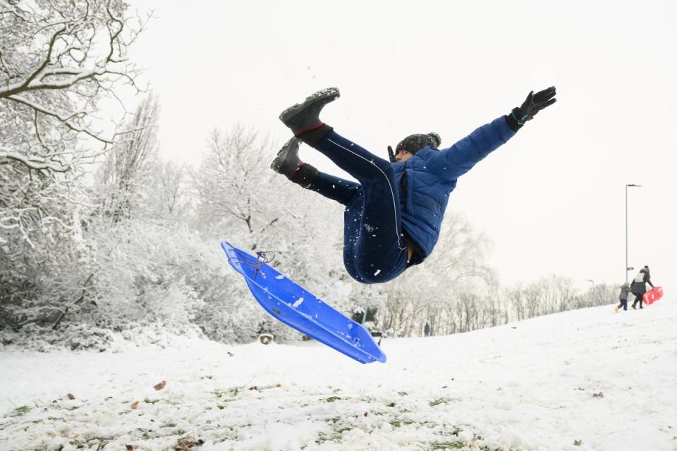 A man takes to the air after hitting a ramp while sledging in Alexandra Palace Park (Getty Images)