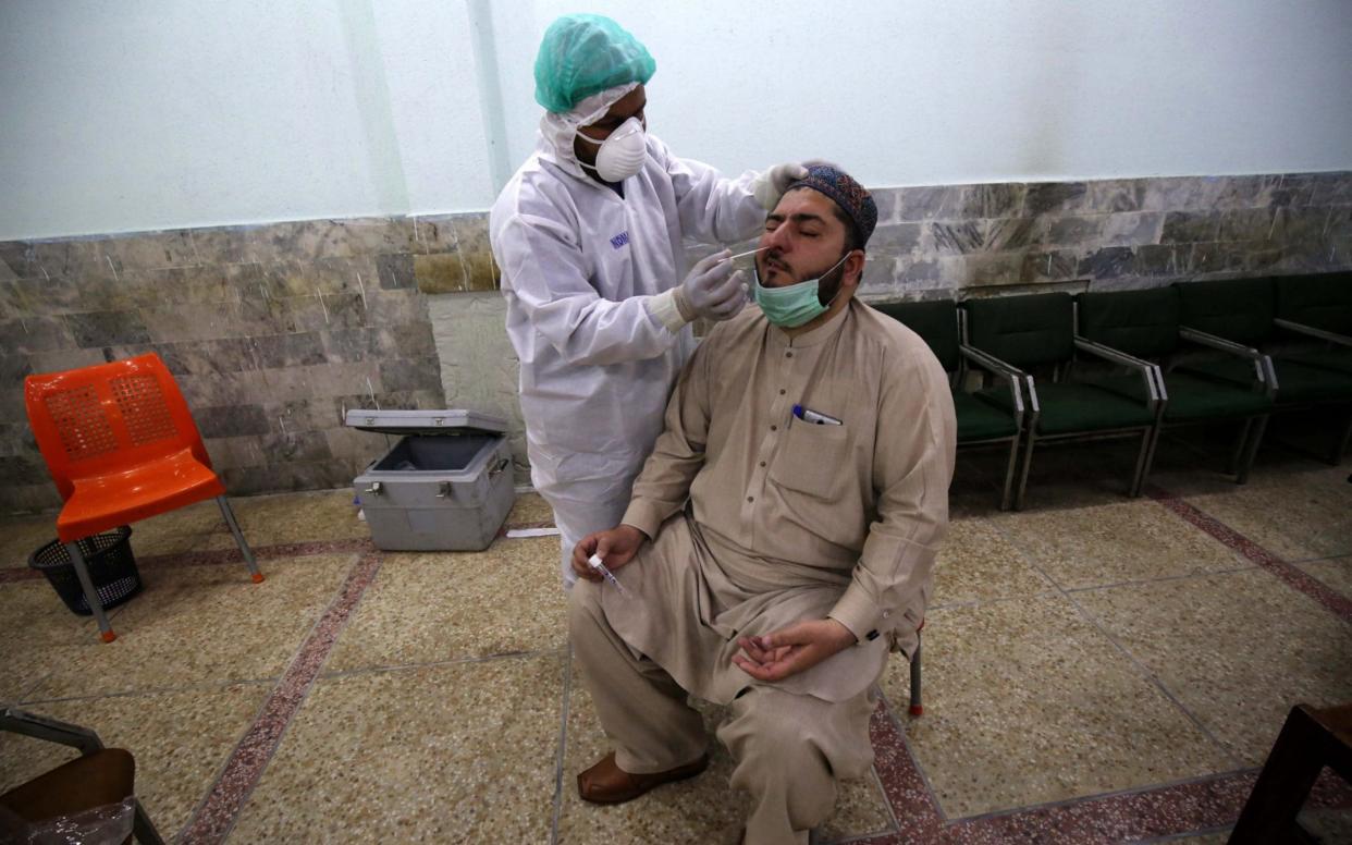 A health official conducts a COVID-19 test on a journalist in Peshawar, Pakistan 03 June 2020. Countries around the world are taking increased measures to stem the widespread of the SARS-CoV-2 coronavirus which causes the Covid-19 disease. Coronavirus COVID-19 testing in Pakistan, Peshawar - 03 Jun 2020 - Shutterstock