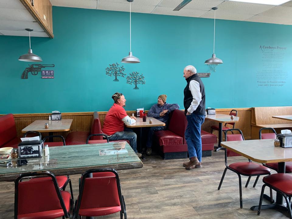 Republican presidential candidate Asa Hutchinson chats with patrons at Outlaw Pizza restaurant during a campaign stop in Corydon, Iowa, on Nov. 30, 2023.