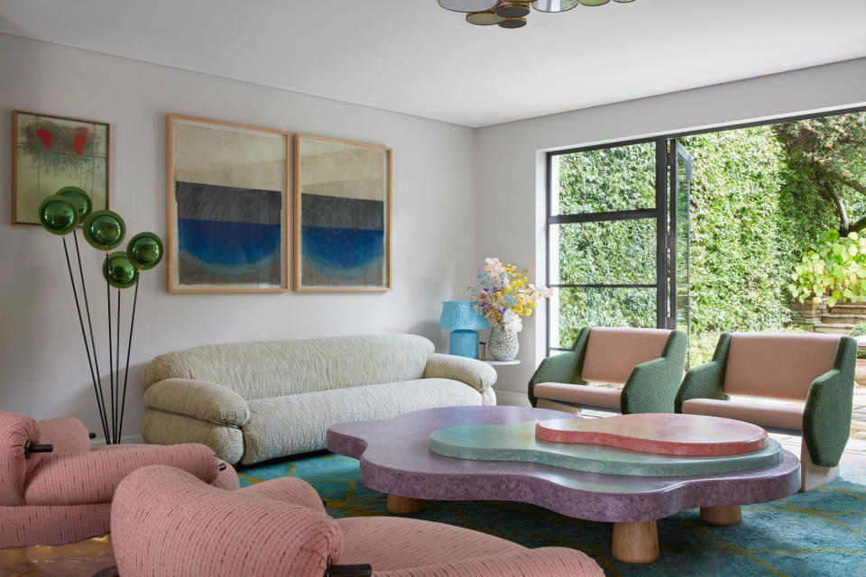 a living room with pastel seating and coffee table