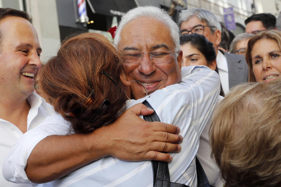 Portuguese Prime Minister and Socialist Party leader Antonio Costa receives a hug from a supporter during an election campaign action in downtown Lisbon Friday, Oct. 4, 2019. Portugal will hold a general election on Oct. 6 in which voters will choose members of the next Portuguese parliament. The ruling Socialist Party hopes an economic recovery during its four years of governing will persuade voters to return the party to power. (AP Photo/Armando Franca)