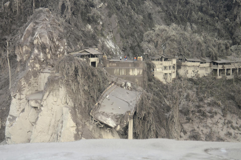 Remains of a bridge is seen in a slope, destroyed by the flowing lava by the eruption of Mount Semeru in Lumajang, East Java, Indonesia, Sunday, Dec. 5, 2021. The death toll from eruption of the highest volcano on Indonesia's most densely populated island of Java has risen with scores still missing, officials said Sunday as rain continued to pound the region and hamper the search. (AP Photo/Hendra Permana)