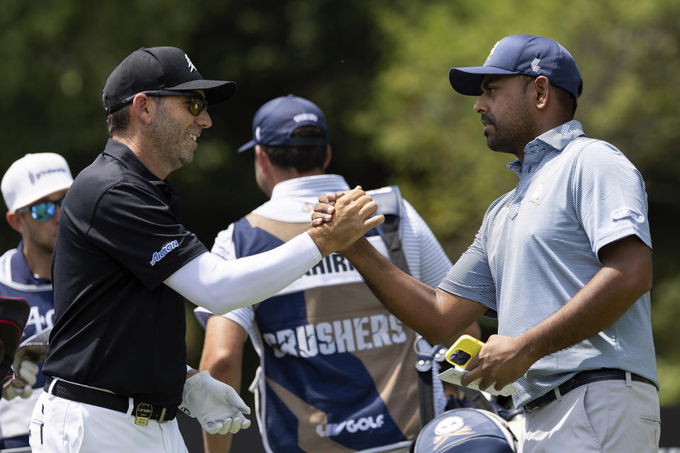 Captain Sergio Garcia, left, of Fireballs GC shakes hands with Anirban Lahiri of Crushers GC on the 10th hole during the second round of LIV Golf tournament at The Greenbrier, Saturday, Aug. 5, 2023 in White Sulfur Springs, W.Va. (Photo by Scott Taetsch/LIV Golf via AP)