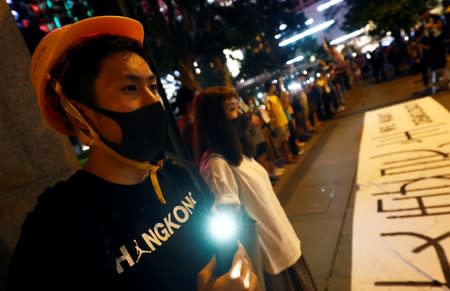 Protesters hold hands to form a human chain during a rally to call for political reforms in Hong Kong's Central district