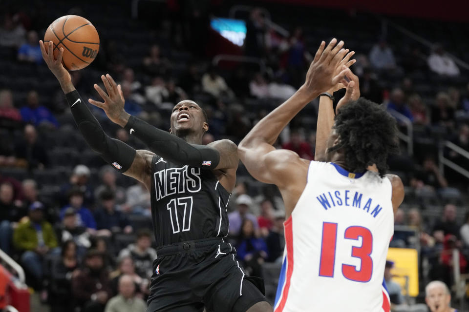 Brooklyn Nets guard Dennis Schroder (17) attempts a layup as Detroit Pistons center James Wiseman (13) defends during the first half of an NBA basketball game, Thursday, March 7, 2024, in Detroit. (AP Photo/Carlos Osorio)