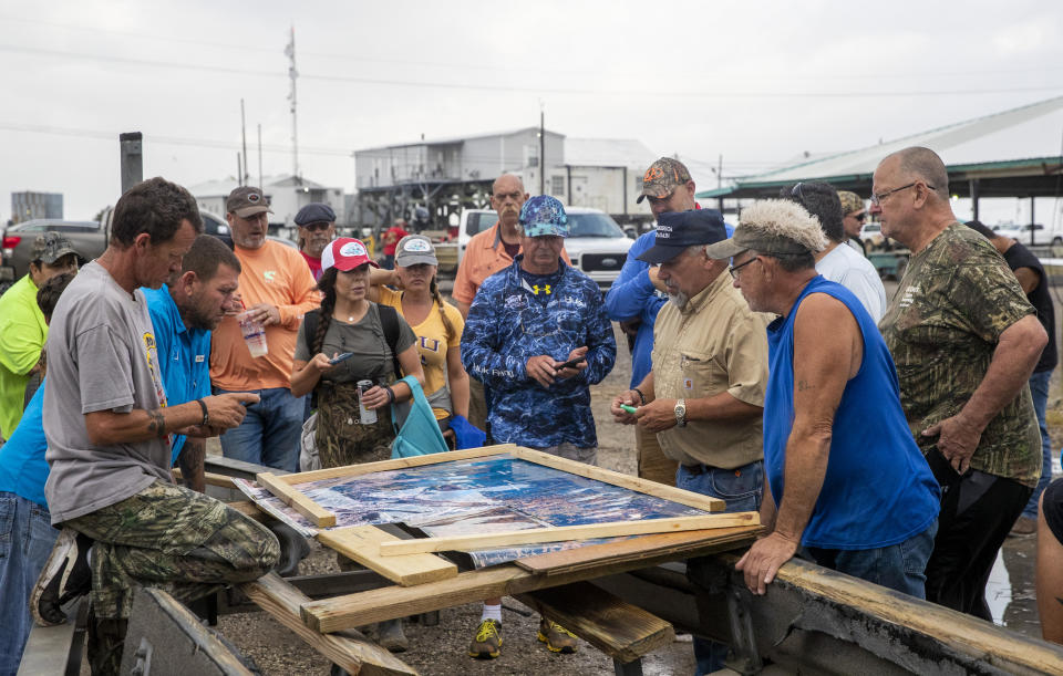 Scott Daspit, the father of missing Seacor Power crew member Dylan Daspit, suggests where people should search based on areas already visited, at Harbor Light Marina in Cocodrie, La., Tuesday, April 27, 2021. The United Cajun Navy and other volunteers joined forces to locate 7 missing Seacor Power crew members almost 2 weeks after the lift boat capsized about 8 miles from Port Fourchon during bad weather. (Sophia Germer/The Advocate via AP)