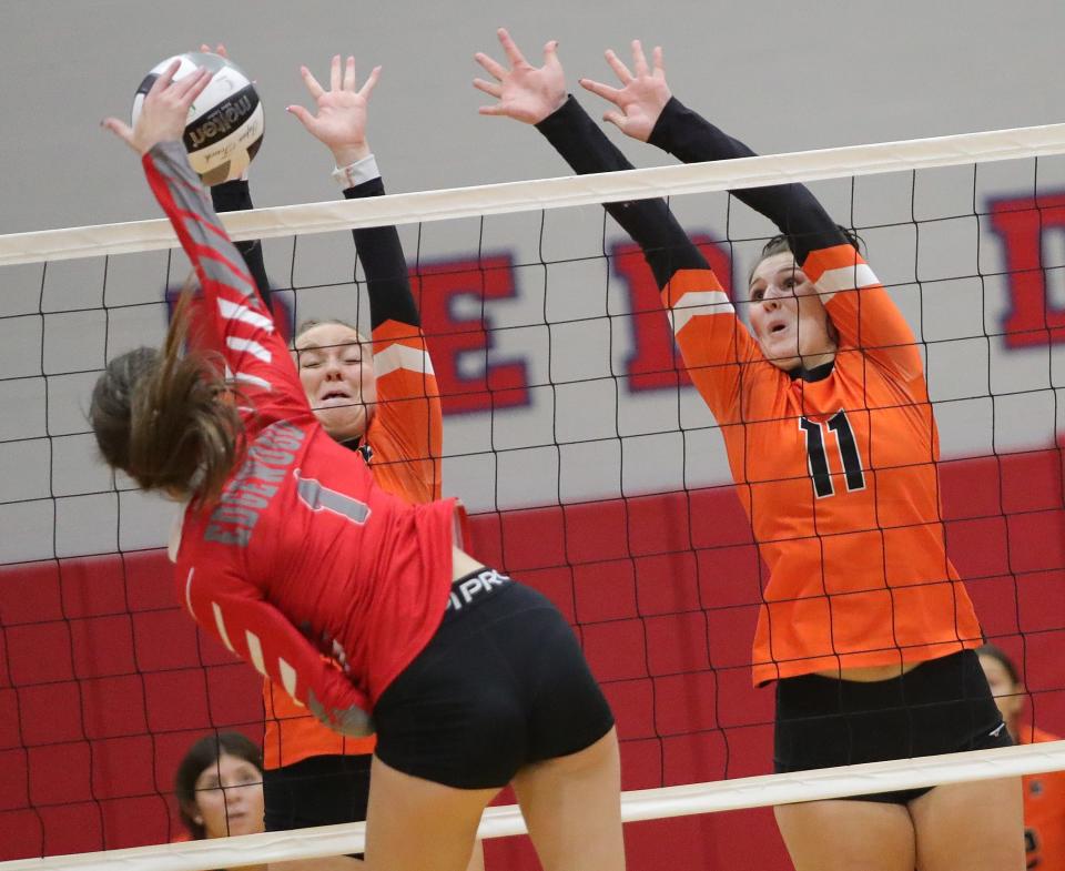 Marlington's Chelsea Evanich, right, Janelle Swisher, left, block against Edgewood's Faith Vencill during a district semifinal, Wednesday, Oct. 25, 2023, in Niles.