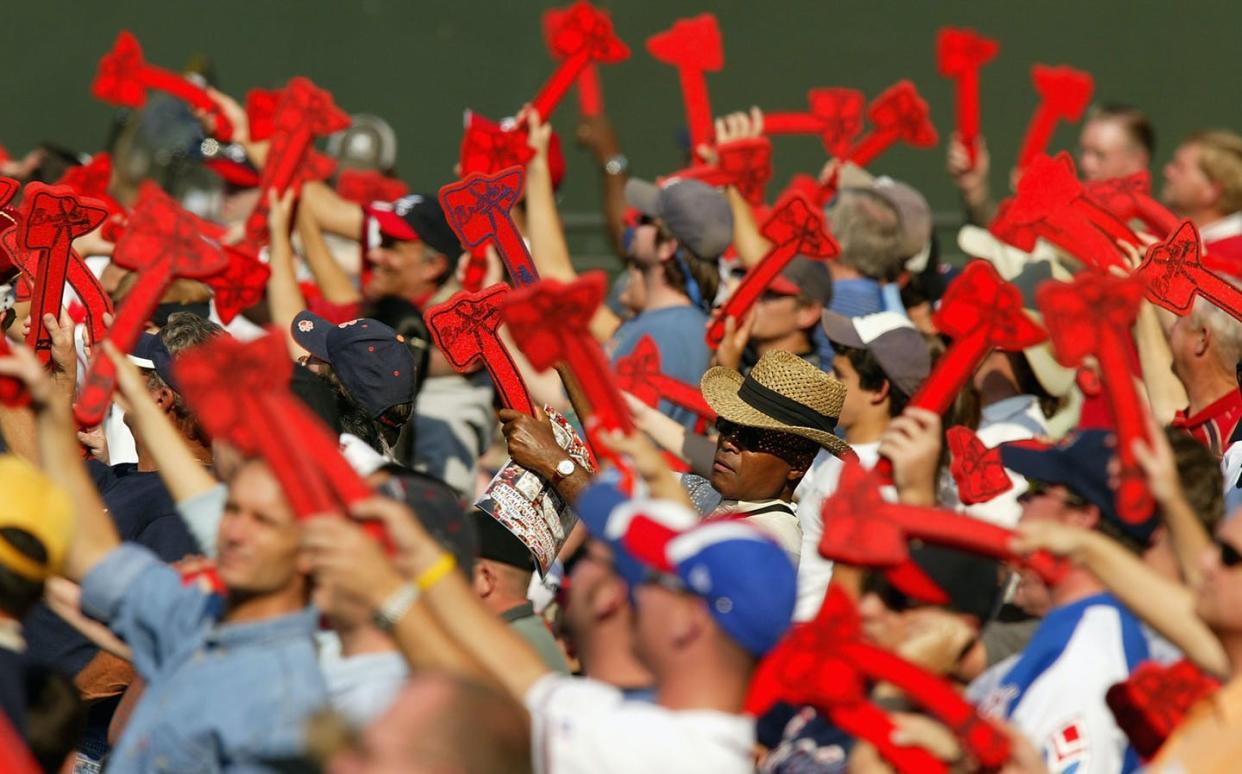 <span class="caption">Atlanta Braves fans perform the 'tomahawk chop' during a playoff game in 2004.</span> <span class="attribution"><a class="link " href="https://www.gettyimages.com/detail/news-photo/fans-of-the-atlanta-braves-do-the-tomahawk-chop-during-news-photo/51433584?adppopup=true" rel="nofollow noopener" target="_blank" data-ylk="slk:Streeter Lecka/Getty Images;elm:context_link;itc:0;sec:content-canvas"> Streeter Lecka/Getty Images</a></span>