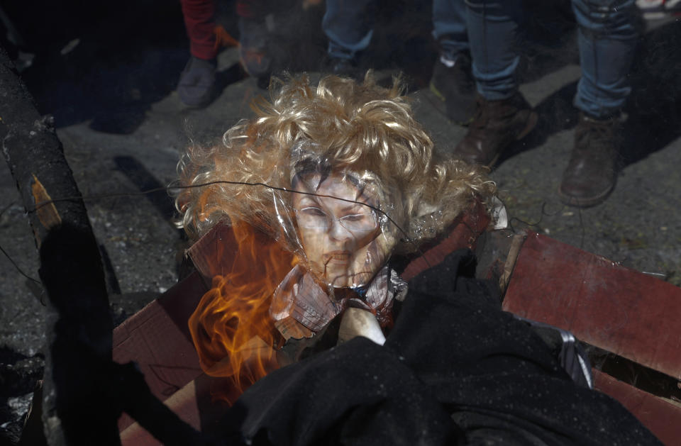 FILE - In this July 28, 2020 file photo, demonstrators burn an effigy of Bolivia's interim President Jeanine Anez during a protest against the postponement of the upcoming presidential election in El Alto, Bolivia. The interim government that replaced former President Evo Morales has been accused of undermining Bolivia's democratic institutions. (AP Photo/Juan Karita, File)