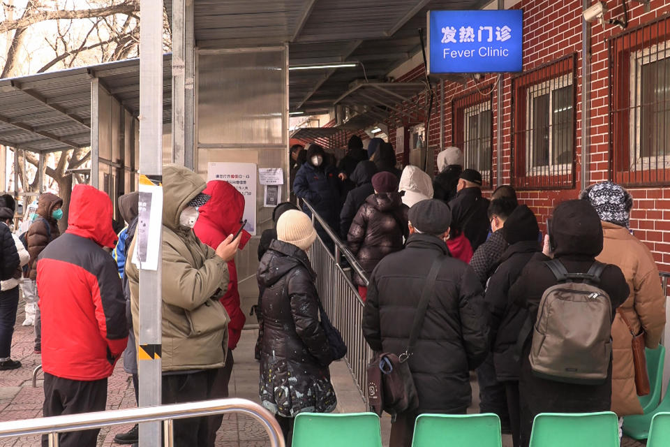 People line up outside a fever clinic in Beijing, China, to seek testing and treatment amid the ongoing COVID-19 pandemic,   December 14, 2022. / Credit: YUXUAN ZHANG/AFPTV/AFP/Getty
