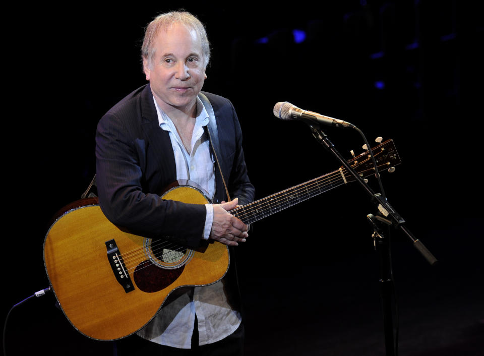 FILE - In a Monday, April 2, 2012 file photo, singer Paul Simon performs at "A Celebration of Paul Newman's Dream" to benefit "SeriousFun" an association of Hole in the Wall Camps at Avery Fisher Hall in New York. Stephen Sondheim and Simon made a joint stage appearance Tuesday night, Dec. 3, 2013, at a small auditorium in downtown Manhattan. Their one-hour conversation was sponsored by the MacDowell artist colony. (AP Photo/Evan Agostini, File)