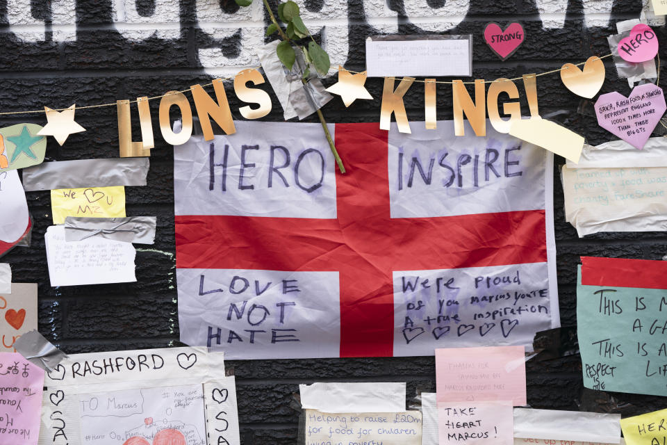 A view of the messages of support left on a mural of Manchester United striker and England player Marcus Rashford, on the wall of the Coffee House Cafe on Copson Street, in Withington, Manchester, England, Tuesday July 13, 2021. The mural was defaced with graffiti in the wake of England losing the Euro 2020 soccer championship final match to Italy. (AP Photo/Jon Super)