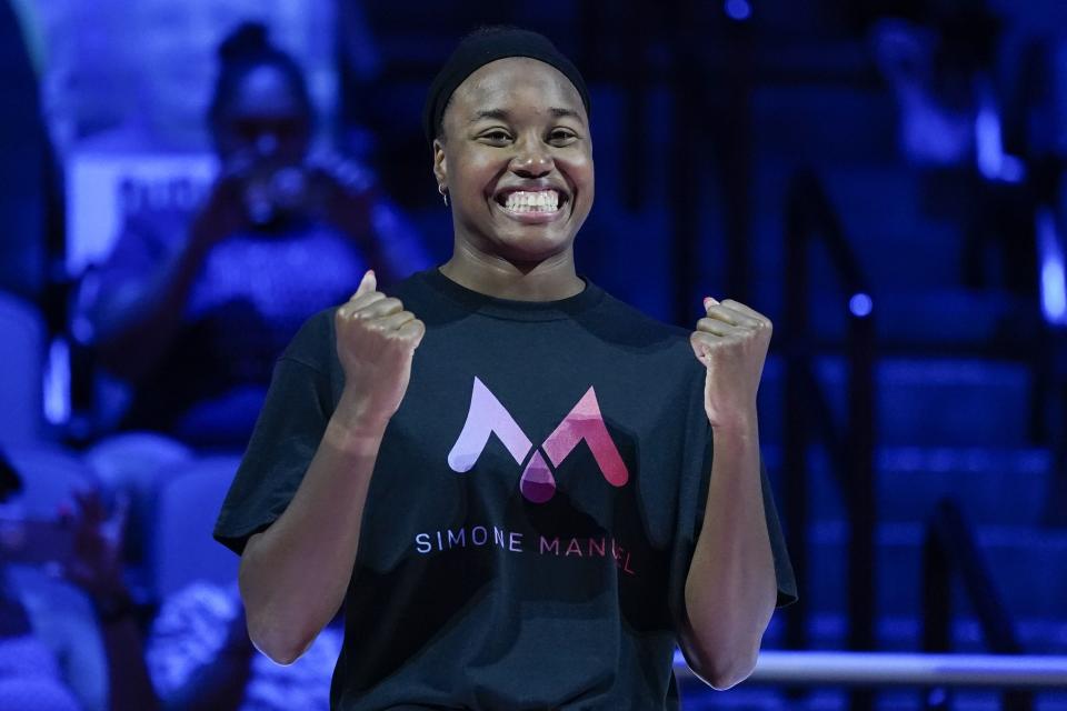 Simone Manuel reacts at the medal ceremony for the women's 50 freestyle during wave 2 of the U.S. Olympic Swim Trials on Sunday, June 20, 2021, in Omaha, Neb. (AP Photo/Charlie Neibergall)