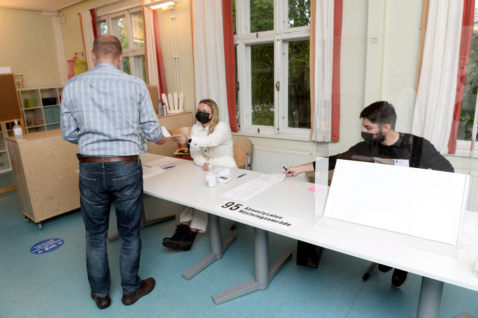 People vote as the polling stations open in the morning during the municipal elections at Finnoo school in Espoo, Finland on Sunday, June 13, 2021.(Mikko Stig/Lehtikuva via AP)