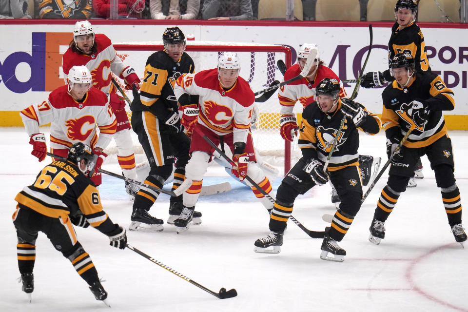 Pittsburgh Penguins' Erik Karlsson (65) controls the puck during a power play in the first period of the team's NHL hockey game against the Calgary Flames in Pittsburgh, Saturday, Oct. 14, 2023. (AP Photo/Gene J. Puskar)